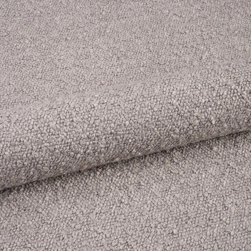 A close-up of a light gray textured fabric with a soft, looped pile, shown folded to highlight its tactile surface.
