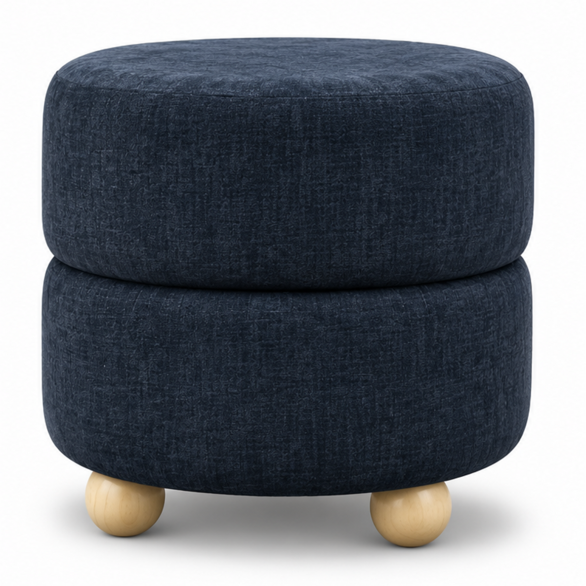 A round two-tier upholstered ottoman in dark navy blue fabric with light natural wood ball feet, shown in a styled living room setting on the left and as a clean studio product shot on the right.